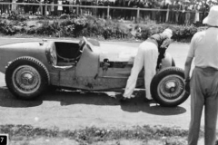 87. Type 59 ACF 23 June 1935 (Montlhery). Car 24, Robert Benoist. Refitting his cars errant bonnet. (retired later in race).