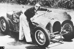 91A. Type 59 ACF 23 June 1935 (Montlhery). Car 24, Robert Benoist. Refitting his cars errant bonnet. (retired later in race).