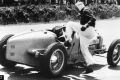 92. Type 59 ACF 23 June 1935 (Montlhery). Car 24, Robert Benoist. Leaps into the cockpit after refitting his cars errant bonnet. (retired later in race).