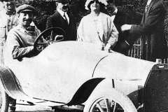 140. Barbara &amp; Ettore Bugatti Barbara Bugatti behind car with Ettore Bugatti behind her and Rembrandt Bugatti next to her, Friderich driving.