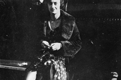 214. Lidia Bugatti sitting on running board of car